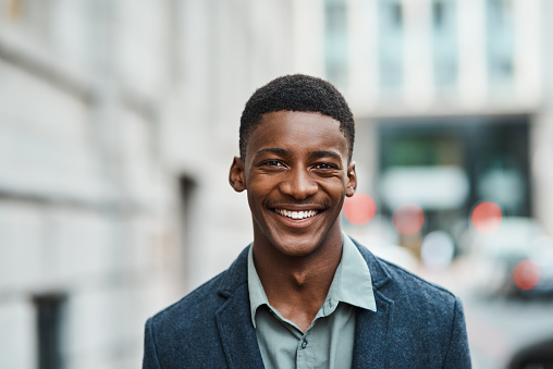 Portrait of a confident young businessman standing against an urban background Portrait of a confident young businessman standing against an urban background